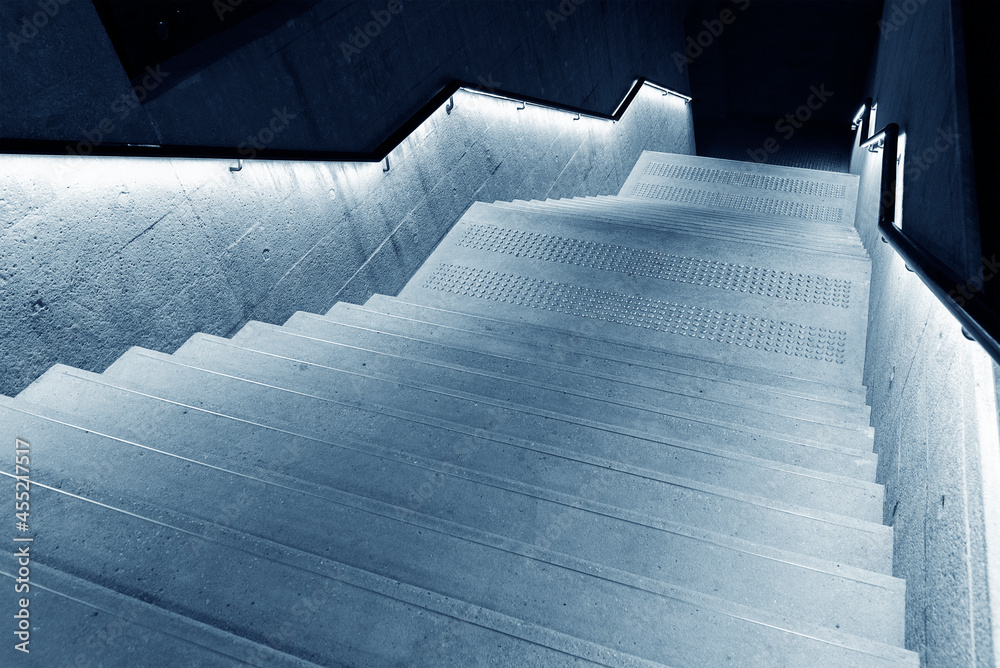 Poster Interior view of empty stairway with illuminated banister in modern architecture