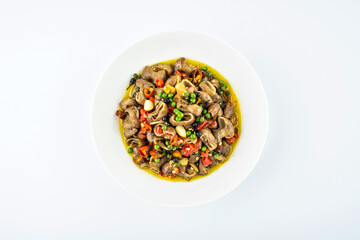 Fried large intestine with mountain pepper on a dish on white background