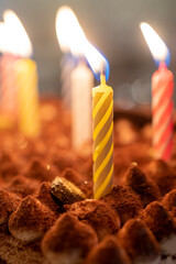 Festive background with burning candles in the cake