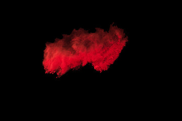 Explosion of colored powder on black background