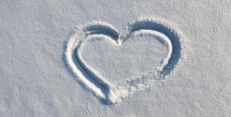 a heart symbol drawn on snow