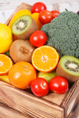 Fresh fruits with vegetables in rustic box as food containing healthy minerals and vitamins