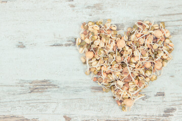Lentils and chickpeas healthy sprouts in shape of heart containing vitamins and minerals