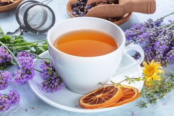 Tea with herbs, flowers and fruit, healthy organic remedy. With orange and lavender