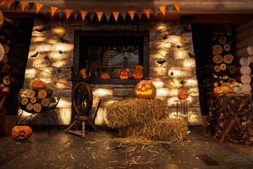 Background for halloween of glowing pumpkins, wall and firewood on a dark background