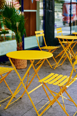 Street cafe interior with yellow table and chairs