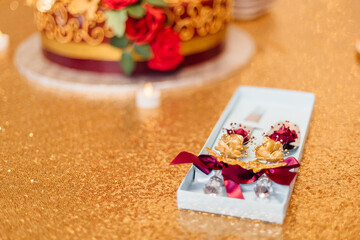 Red and gold festive decoration. Cookies, flowers, food on the birthday table. Wedding table. Festive background