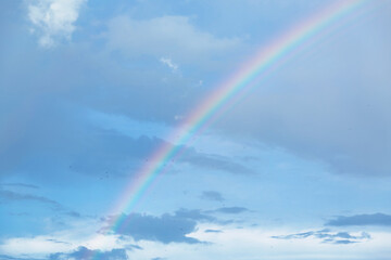 Fototapeta na wymiar Rainbow in the blue sky with clouds.