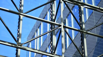 Fragment of glass and metal facade walls. Commercial office buildings. Abstract modern business architecture.