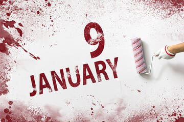 January 9th. Day 9 of month, Calendar date. The hand holds a roller with red paint and writes a...