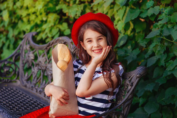 Obraz premium beautiful brunette girl holding a French baguettes