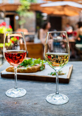 Summer terrace table set with chilled served beverages and snacks on white plates. Party table setting for lunch or dinner in cafe concept..