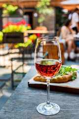 Summer terrace table set with chilled served beverages and snacks on white plates. Party table setting for lunch or dinner in cafe concept..