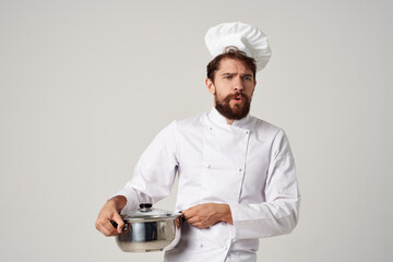 male chef with a saucepan in his hands cooking food kitchen restaurant