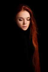 Redhead girl with long hair contrast art portrait. Perfect woman on black background. Gorgeous hair...