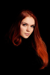 Fototapeta premium Redhead girl with long hair contrast art portrait. Perfect woman on black background. Gorgeous hair and beautiful eyes. Natural beauty, clean skin, facial care and hair. Strong and thick hair