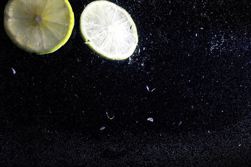 Water drops on ripe sweet lemon. Fresh lime  background with copy space for your text. Vegan concept.