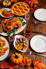 Thanksgiving Day table with turkey, pumpkin pie, roasted vegetables, top view.Thanksgiving dinner and autumn decoration.