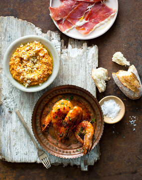 spanish tapas prawns on table with other tapas