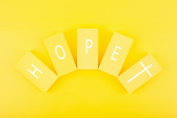 Modern religious minimal concept of hope with christian cross on bright yellow background. Biblical...