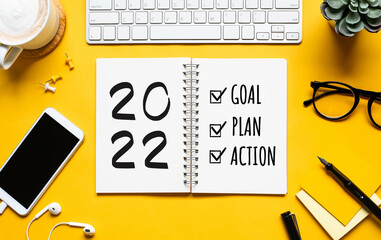2022 new year goal,plan,action concepts with text on notepad and office accessories.Business...