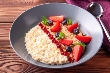 Oatmeal porridge with berries for breakfast.