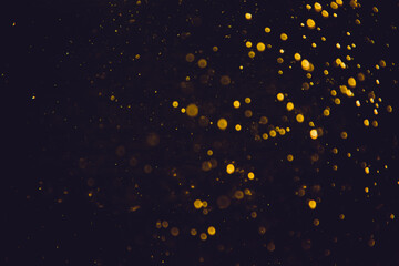 Golden bokeh of lights on black background