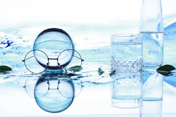 Tools for vision correction. Glasses and lenses with diopters on the background of splashes and blurry.