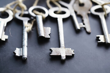 Set of vintage keys for a lock. Retro keys on a dark stone background. The concept of choosing the path to achieve the goal.