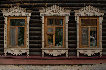 Fototapeta na wymiar an old house, cobblestone walls, windows with decorative trim. wooden architecture. 