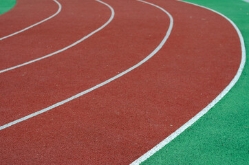 Fototapeta premium Empty running tracks. Red jogging tracks at the stadium. Sports, active lifestyle. Selective focus.
