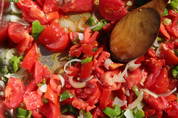 Peppers and onions are roasted for food.