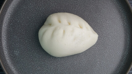 Chinese Hong Kong steamed fresh mixed vegetables carrot bun vegan white bao zi in leaf shape on dark grey wood background asian dim sum halal food restaurant cuisine banquet menu for cafe