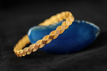 Gold bracelet on blue agate stone
