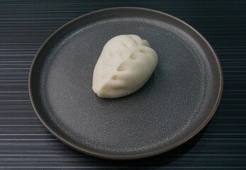 steamed fresh vegetables bun white baozi in leaf shape on dark grey wood background dim sum halal...