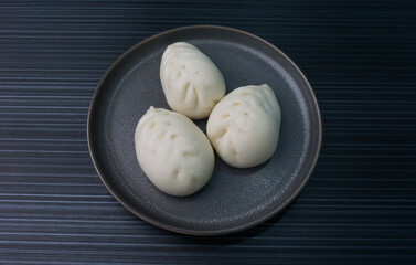 steamed fresh vegetables bun white baozi in leaf shape on dark grey wood background dim sum halal...