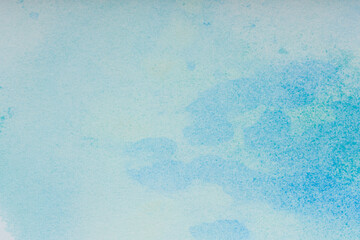 Watercolor background. Blue brush strokes of watercolor paint on white paper.