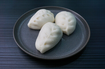 Chinese Hong Kong steamed fresh mixed vegetables carrot bun vegan white bao zi in leaf shape on...