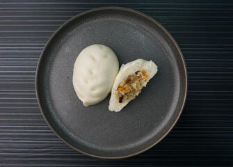 steamed fresh vegetables bun white baozi in leaf shape on dark grey wood background dim sum halal...