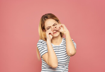 pretty woman in a striped T-shirt discontent upset studio isolated background