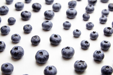 Blueberries with shadows on white table