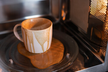 dirty coffee cup after operating with microwave oven, heating water in microwave can be dangerous