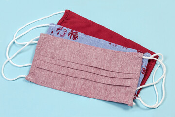 Different fabric protective face masks on a blue background