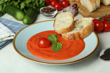 Concept of tasty eating with Gazpacho soup on white textured background