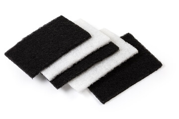 Flat hard synthetic cleaning sponges on a light background