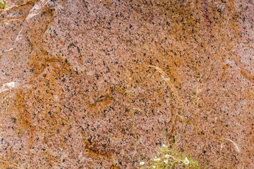 Torn edge of the red gray granite block