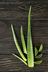 Aloe vera leaves and slices on wooden background