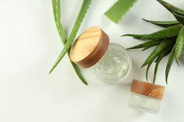 Aloe vera and cosmetics on white background