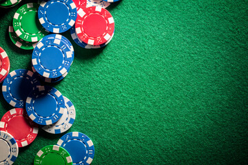 Casino or poker chips on green felt gambling background