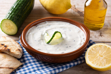 Traditional Greek Tzatziki on rustic wooden table